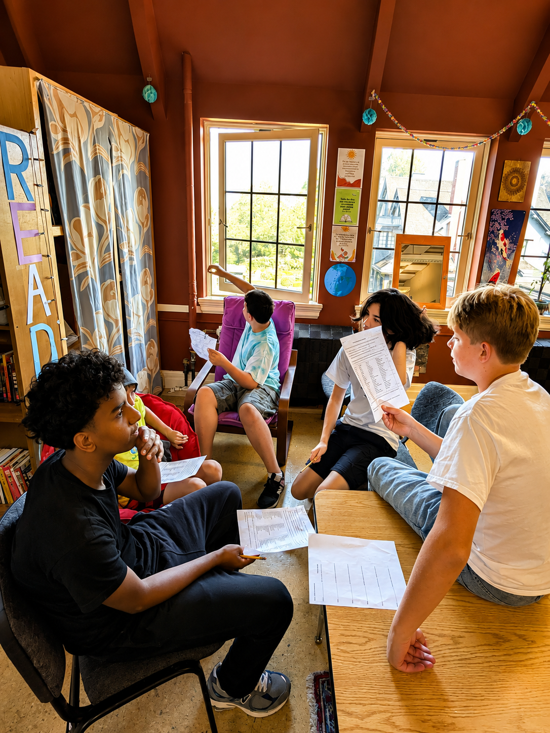 Middle school students discussing a worksheet together in their classroom