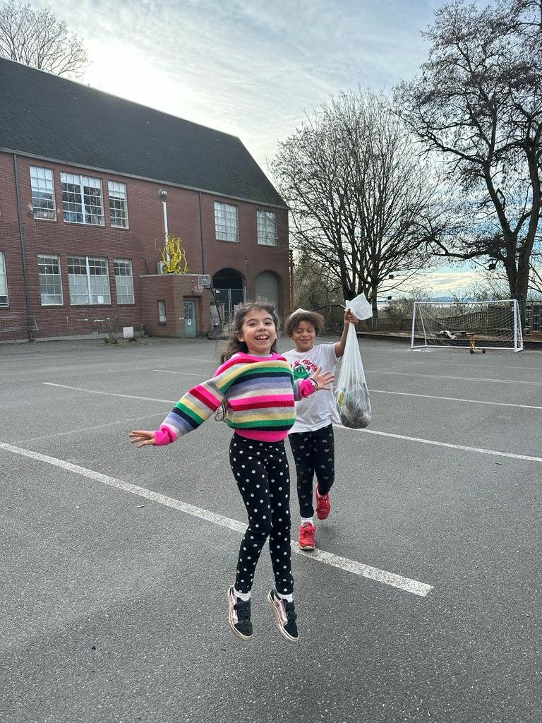 Students jumping and laughing on the playground at recess