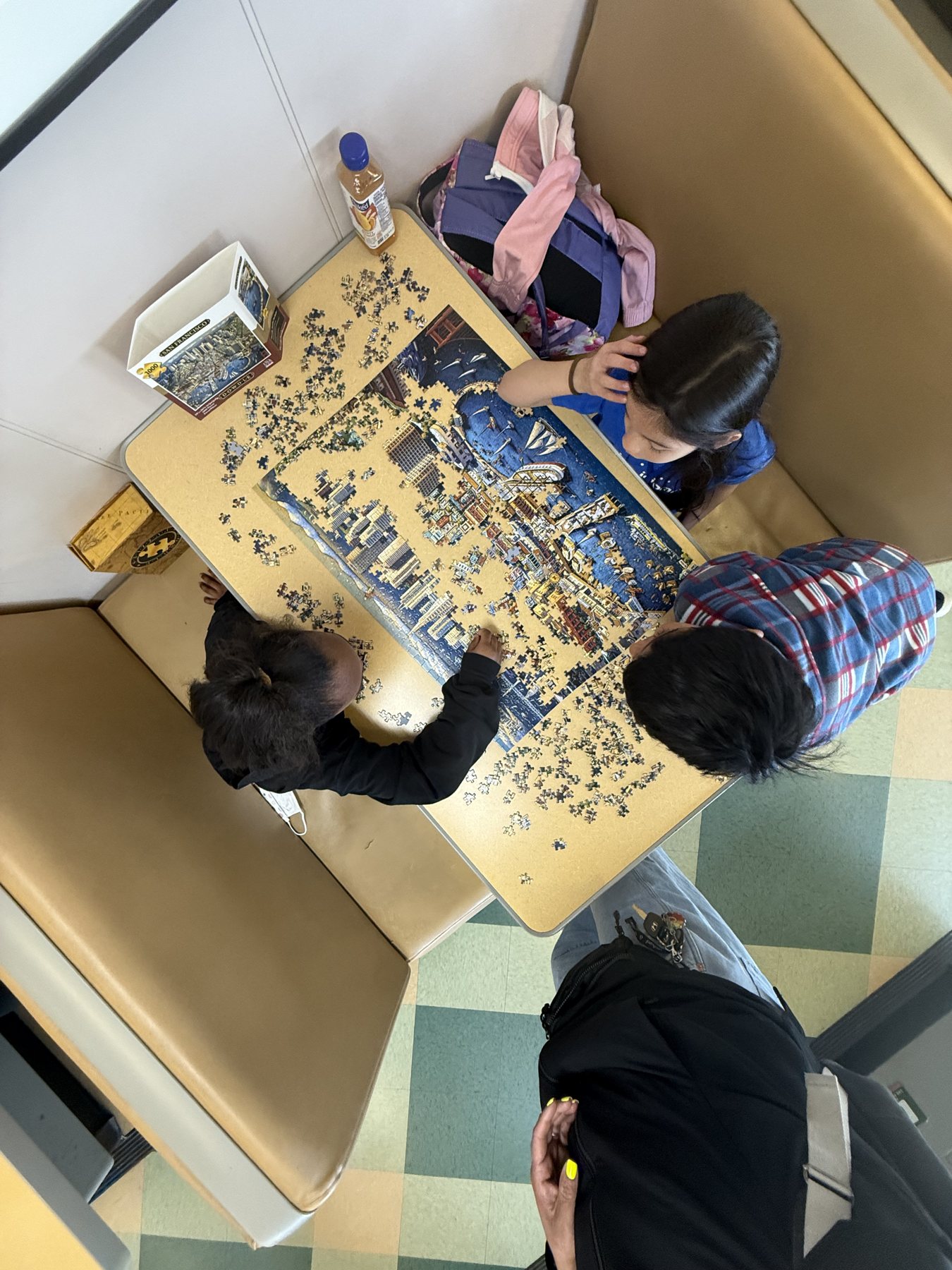 Students working on a puzzle together during extended day