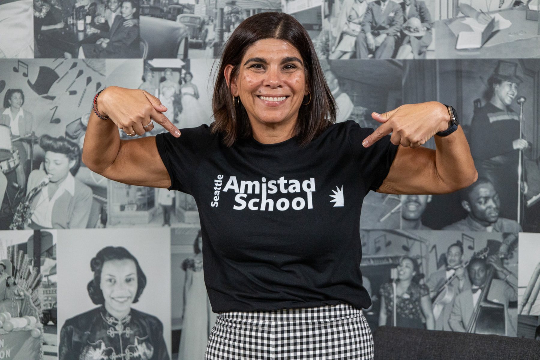 A staff member wearing a Seattle Amistad spirit tee