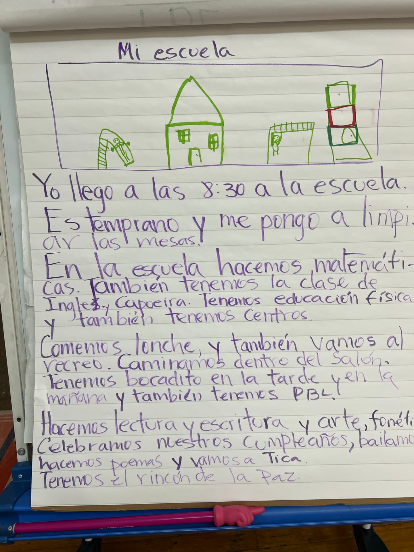 A student's illustrated Spanish writing about their school, titled Mi escuela