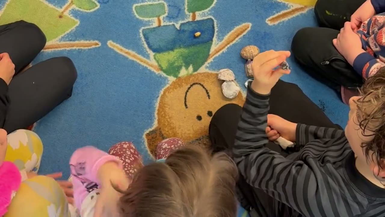 Students gathered on the rug with their teacher for morning circle