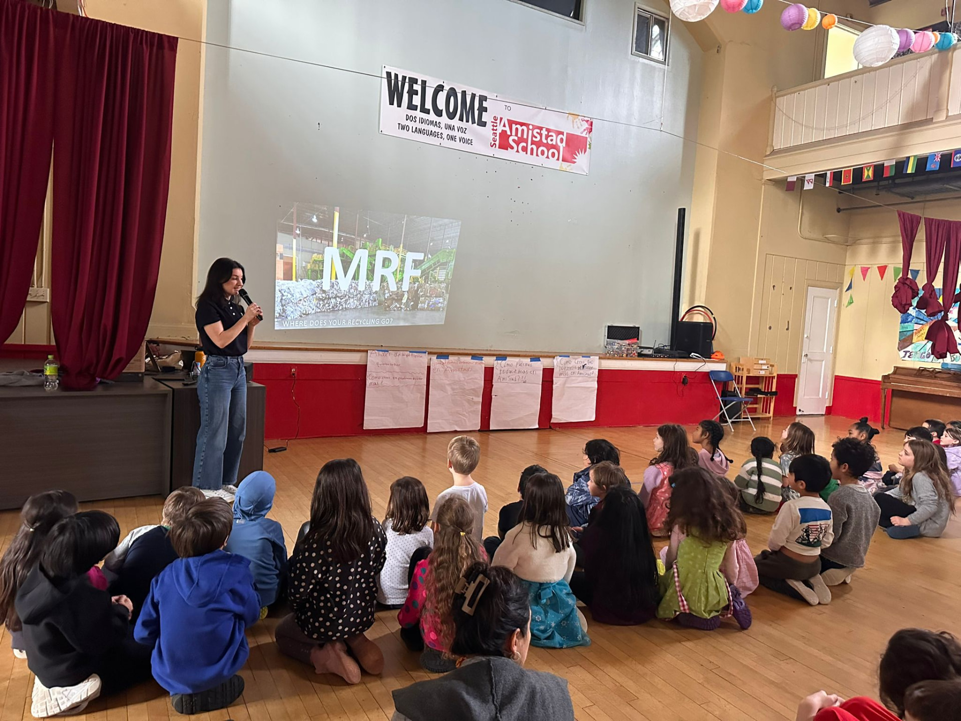 Amistad students presenting together during a school assembly