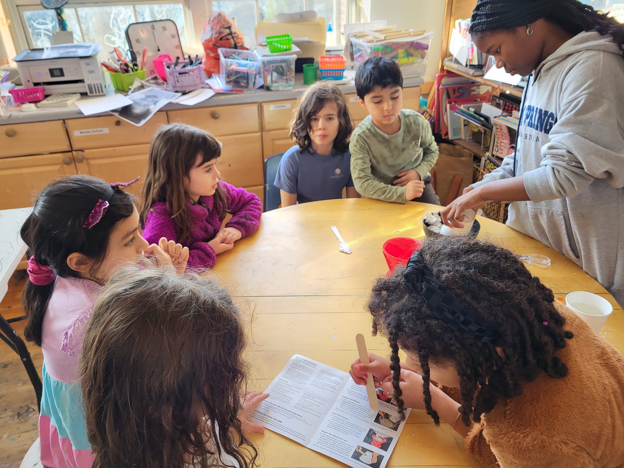 Students and a teacher working together on a hands-on science project