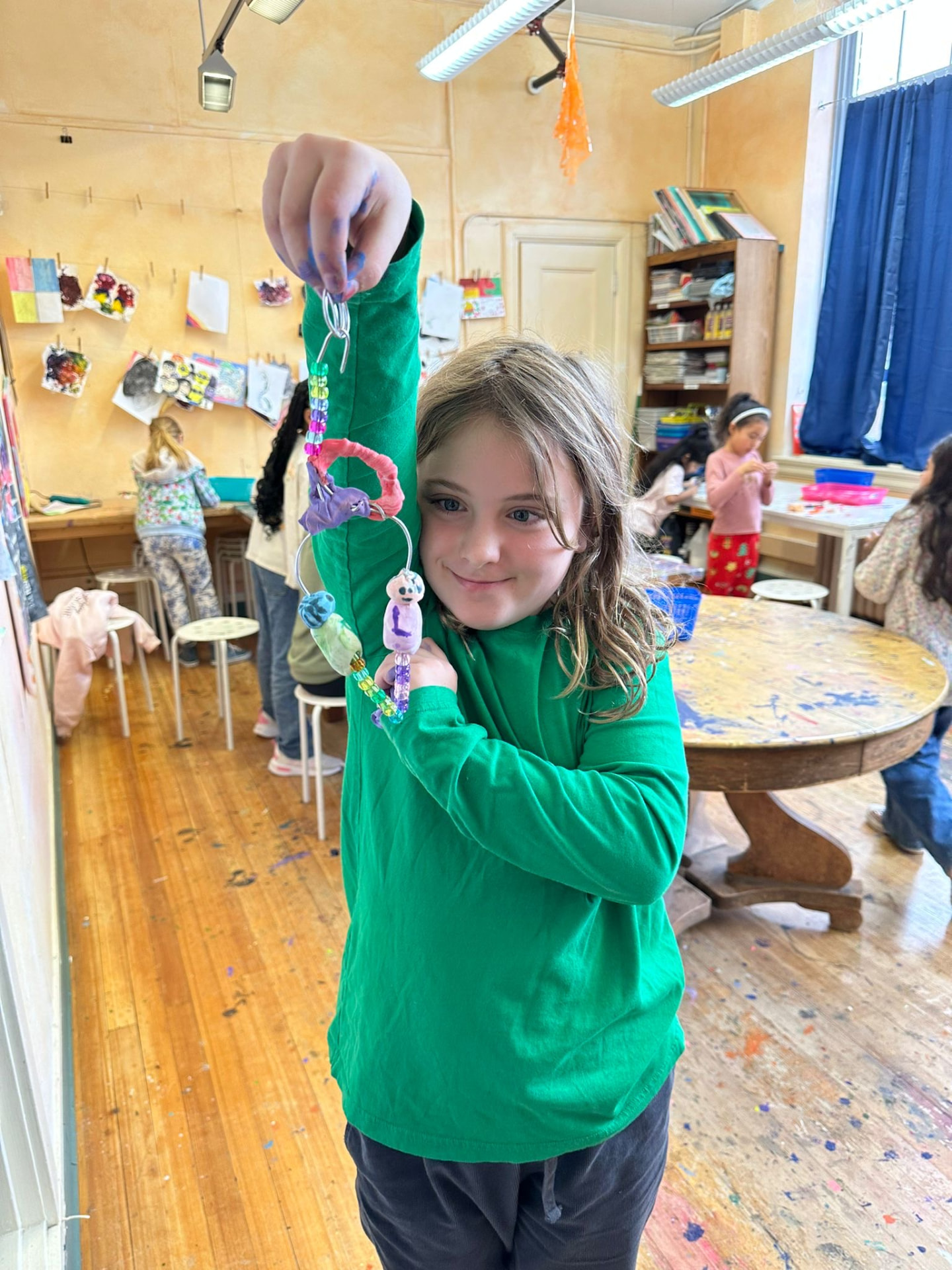 Students creating colorful keychains together in the art studio