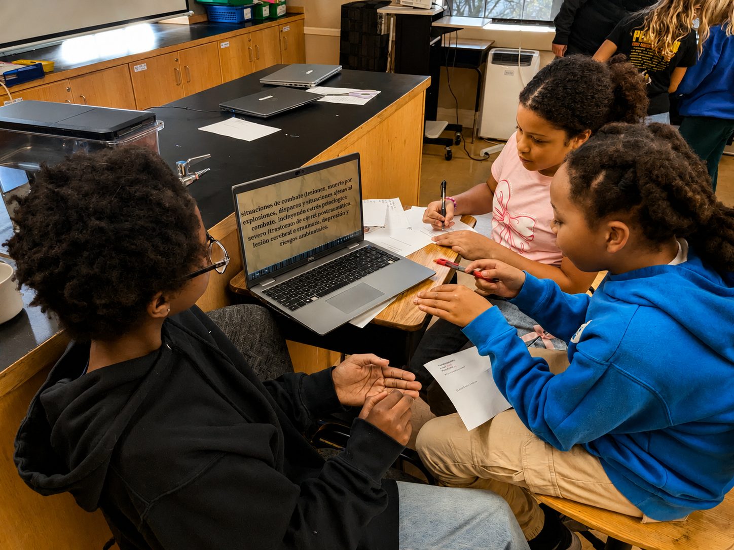Middle school students problem-solving together at a table