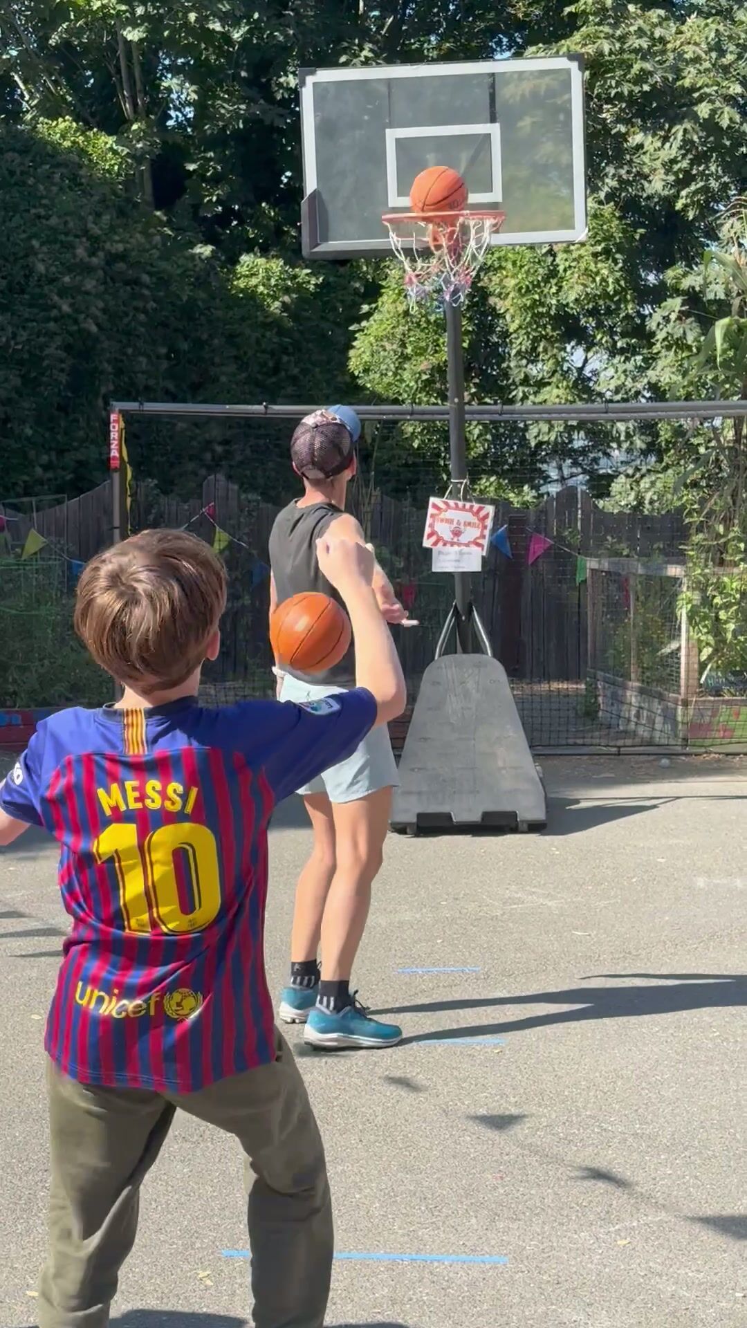 Amistad middle school students shooting hoops on the outdoor court