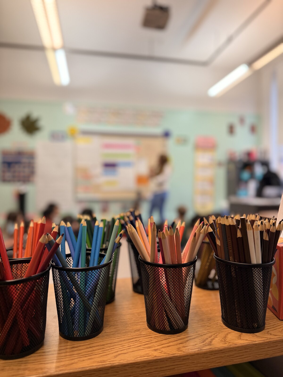 Colored pencils ready on a classroom table during a lesson